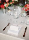 Setting table decorated with flowers — Stock Photo