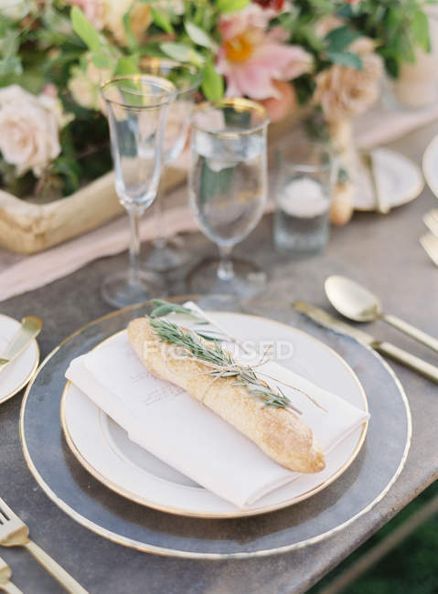 Bread decorated with rosemary sprig — Stock Photo