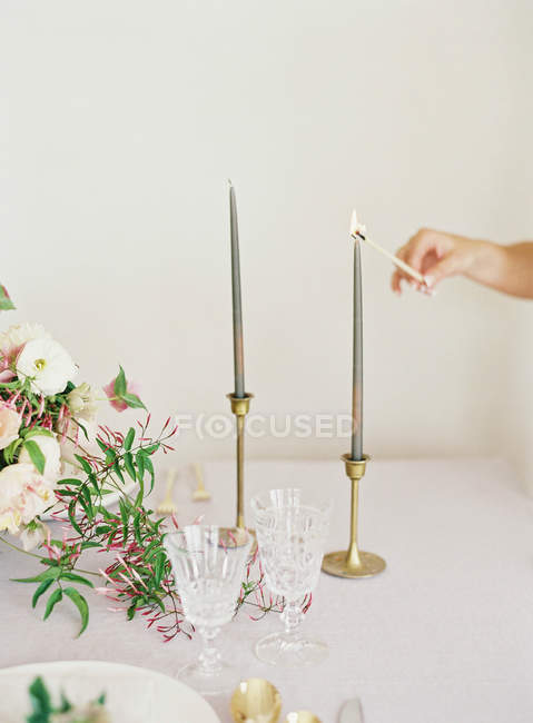 Hand lights candle — Stock Photo