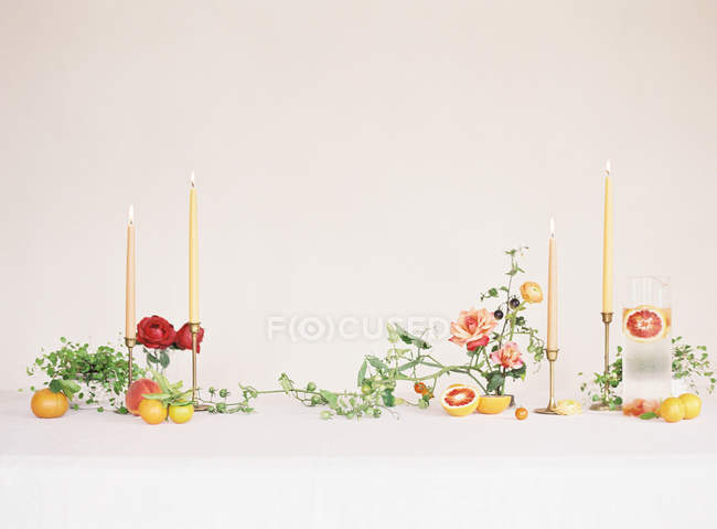 Homemade lemonade with flowers and candles — Stock Photo