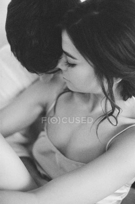 Young couple embracing in bed — Stock Photo