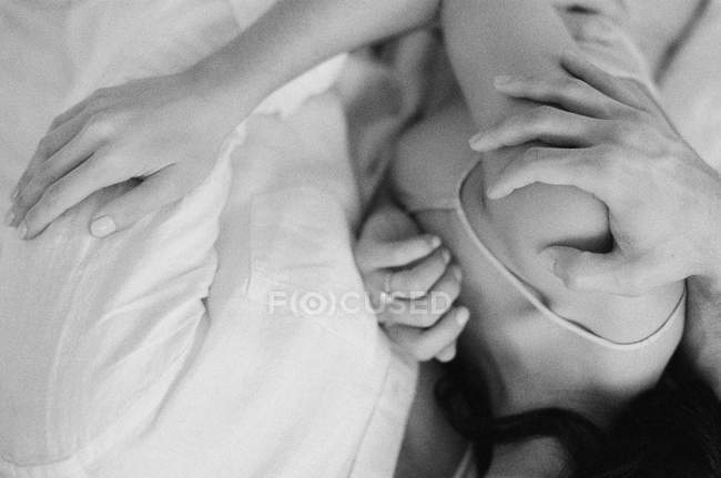 Casal jovem abraçando na cama — Fotografia de Stock