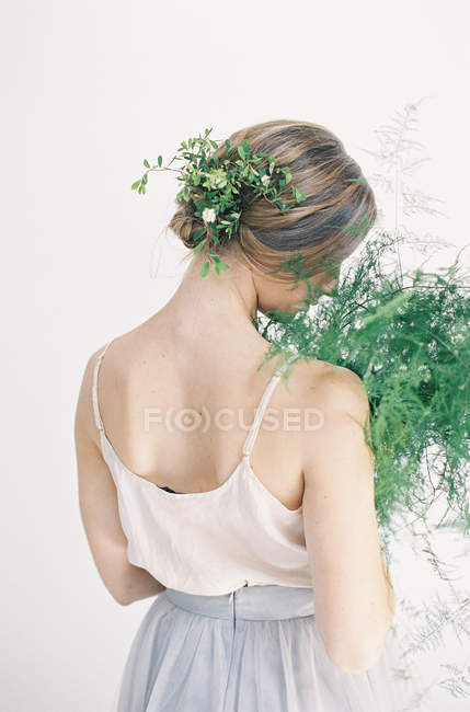 Woman holding fern leaves — Stock Photo