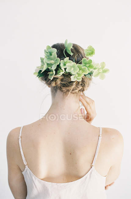 Woman with floral decoration in hair — Stock Photo