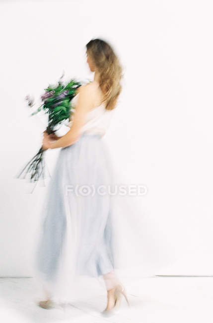 Woman turning in tulle dress — Stock Photo