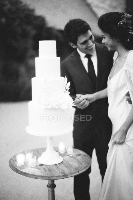 Наречена і наречена вирізають весільний торт — стокове фото