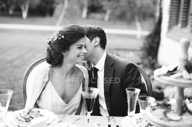 Sposo sussurrando all'orecchio della sposa — Foto stock