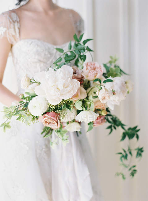 [تصویر:  focused_156616492-stock-photo-bride-holding-bouquet.jpg]