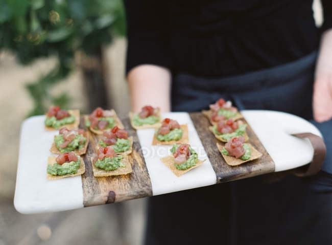 Person serving canapes — Stock Photo