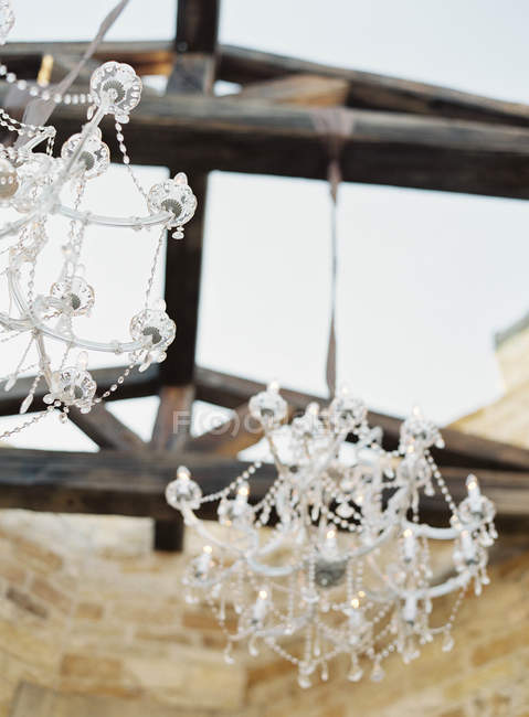 Chandeliers hanging on wooden roof — Stock Photo
