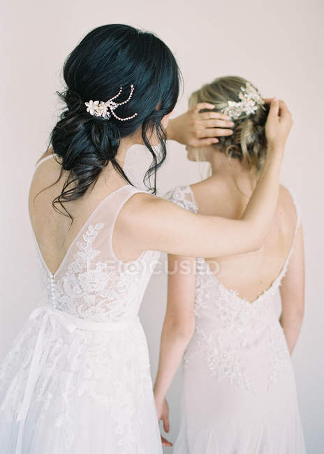 Woman helping friend with hair — Stock Photo