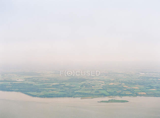 Coastal line and land with fields — Stock Photo
