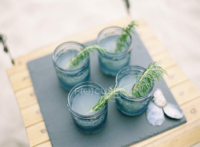 Appetizing drinks with rosemary leaves — Stock Photo