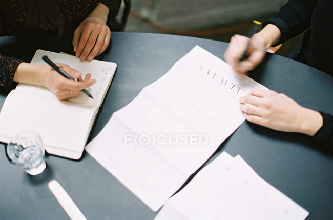 women writing wedding invitations selective focus top view