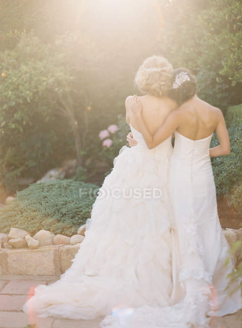 Women in wedding dresses outdoors — Stock Photo