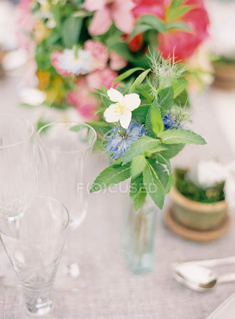 Disposizione floreale sulla tavola apparecchiata — Foto stock