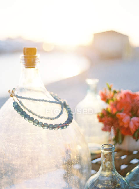 Decorative bottles and flowers — Stock Photo