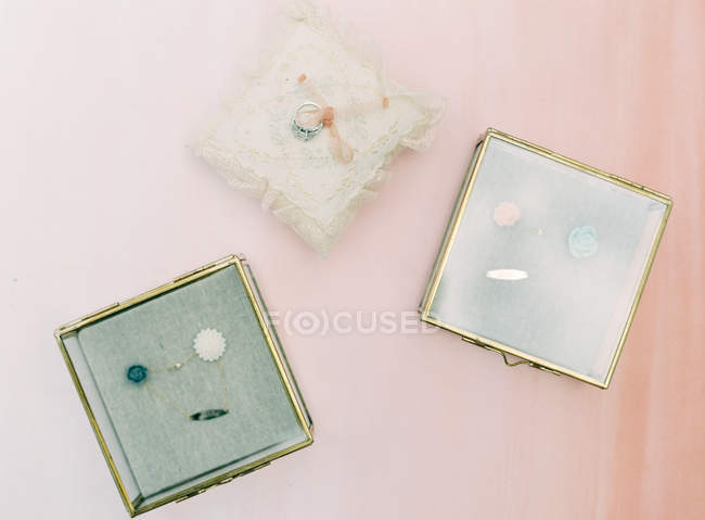 Caskets with jewelery on pink — Stock Photo