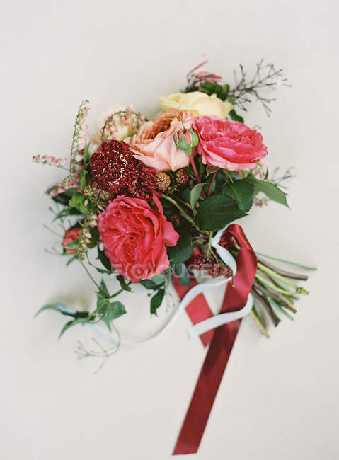 Beautiful bouquet tied with red ribbon — Stock Photo