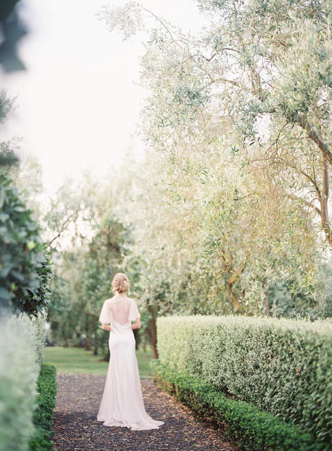 Beautiful bride walking outdoors — Stock Photo