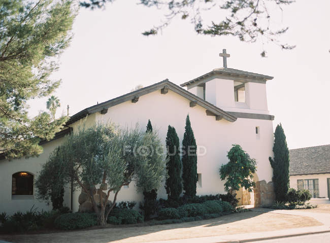 Church building with cedar trees — Stock Photo