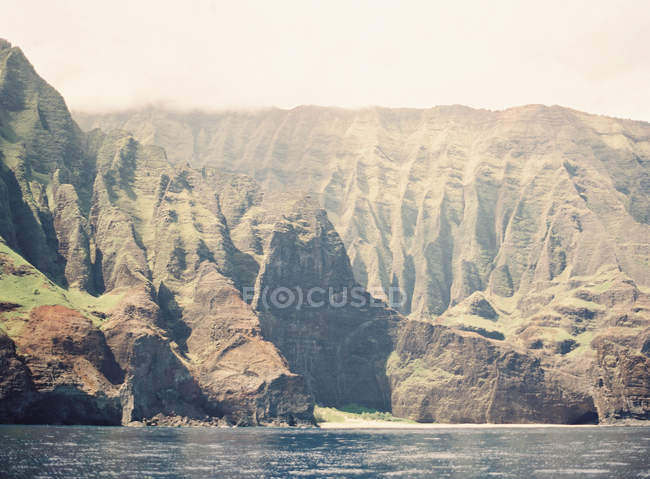 Volcanic island with mountain ridges — Stock Photo