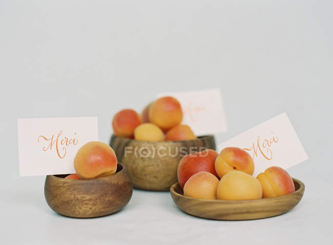 Спелые персики в деревянных чашах — стоковое фото