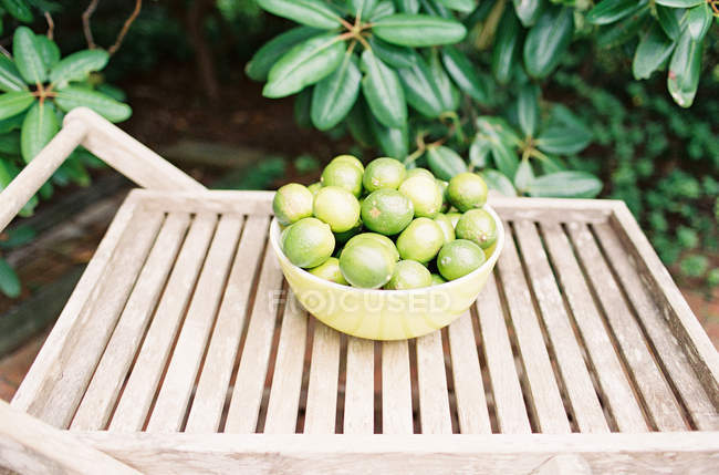 Limas frescas maduras en un tazón - foto de stock