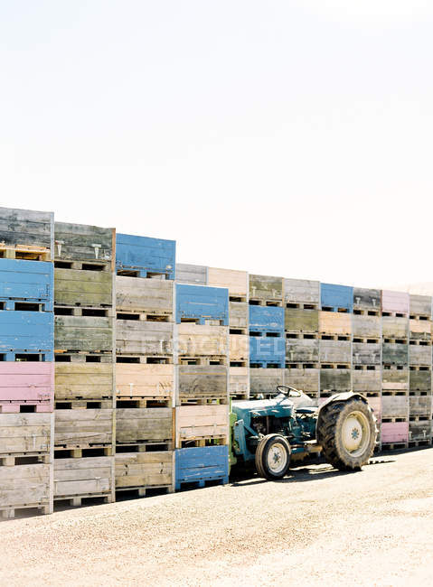 Tractor parked along stacks — Stock Photo