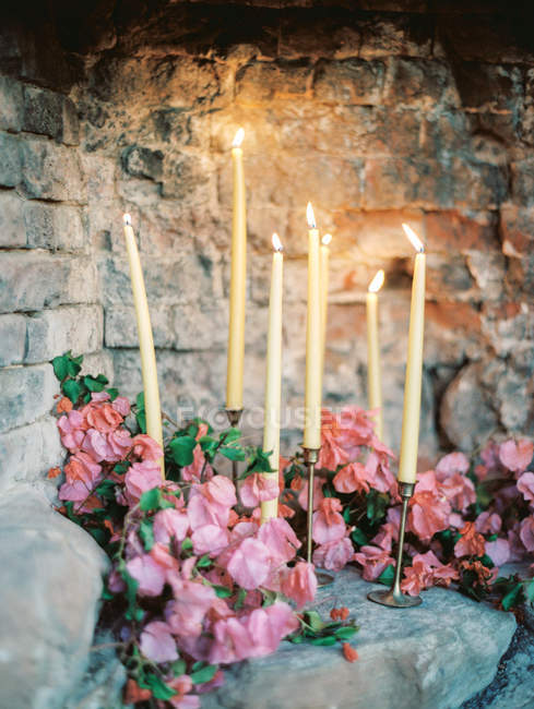 Lighting candles with flowers — Stock Photo