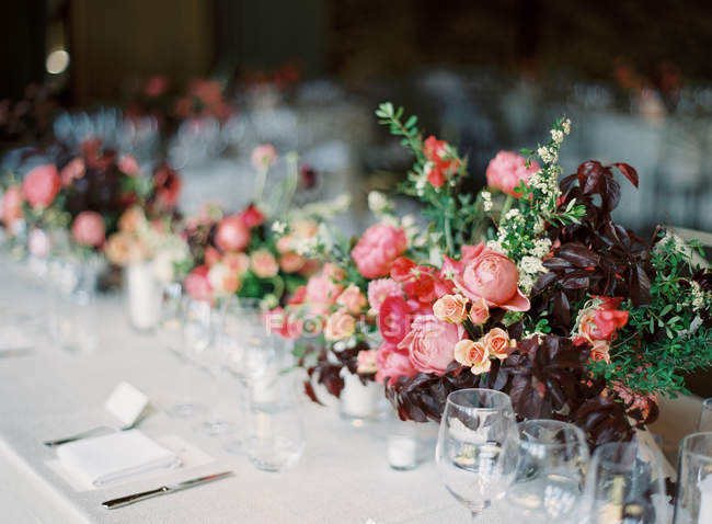 Flower bouquets on set table — Stock Photo