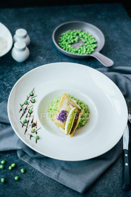 Risotto of green peas with pikeperch — Stock Photo
