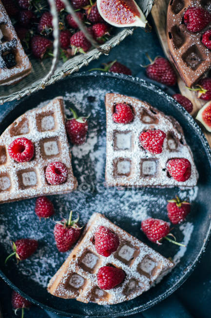 Waffles with raspberries on tray — Stock Photo