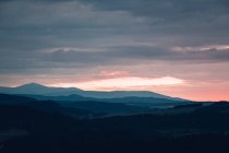 Mountainous landscape with sunset in background — Stock Photo