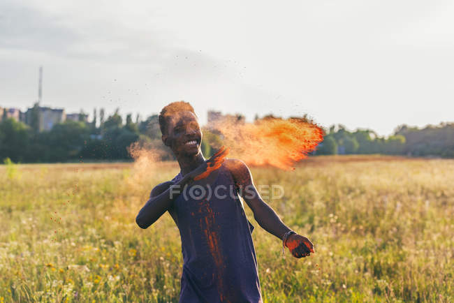 African american man on holi festival — Stock Photo