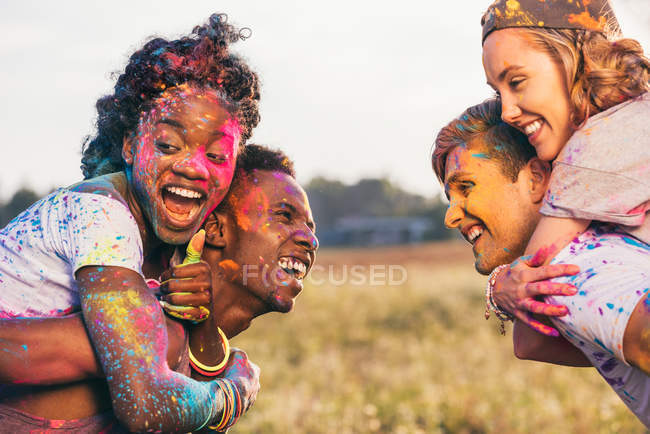 Multiethnic couples at holi festival — Stock Photo