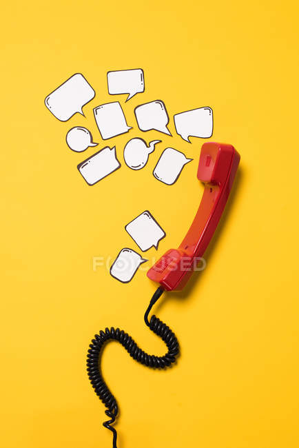 Telephone handset and speech bubbles — Stock Photo