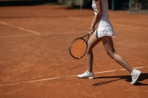 Cropped shot of young sportive woman playing tennis — Stock Photo