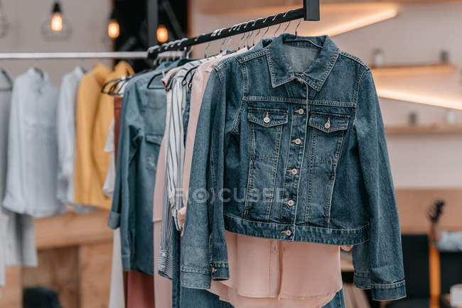 Stylish clothes on hangers — Stock Photo