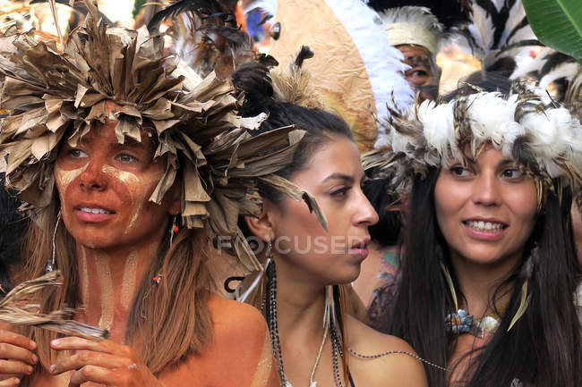 Women in carnival outfit on city street — Stock Photo