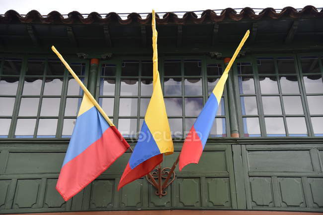 Three flags of Colombia on building — Stock Photo