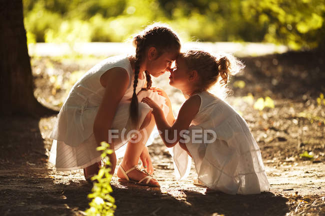 Happy girlfriend sitting in the sun — Stock Photo