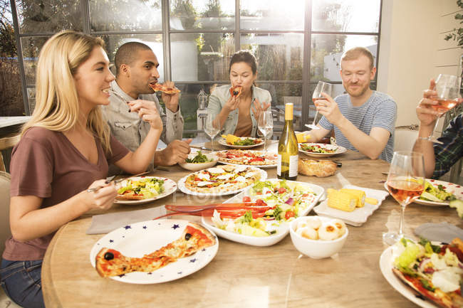 Friends eating dinner together — Color Image, drinking - Stock Photo