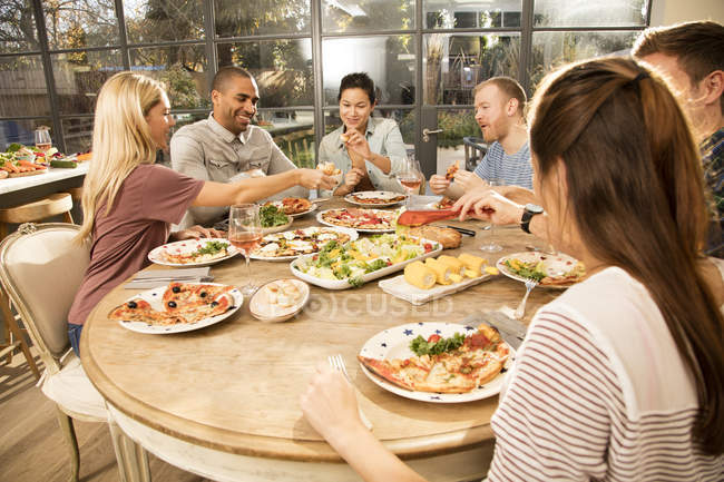 Friends eating dinner together — vegetable, Medium Group Of People