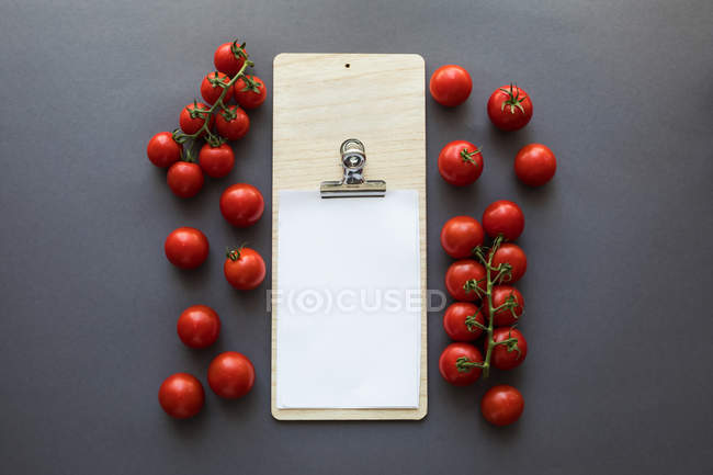 Vegetables with blank paper and cutting board — Stock Photo