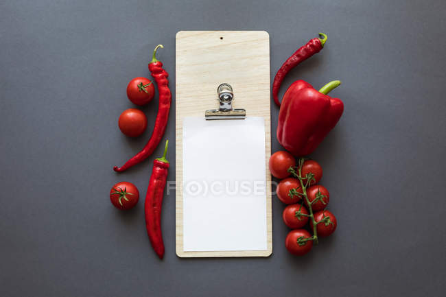 Vegetables with blank paper and cutting board — Stock Photo