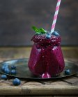 Glass cup of blueberry smoothie with mint — Stock Photo