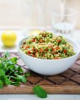 Bowl of bulgur with tomatoes and spinach — Stock Photo