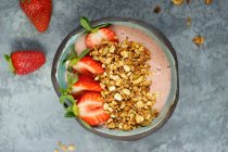Bowl of muesli with strawberries, yogurt and oats — Stock Photo