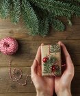 Person holding wrapped gift — Stock Photo